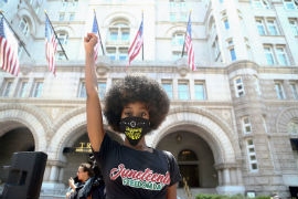 Muka Chisaka, 26, raises her fist in front of Trump International Hotel in Washington D.C. during a Juneteenth Black Lives Matter march on June 19, 2020. (Kaitlin Newman/Zenger)