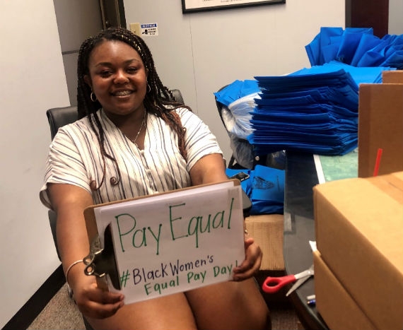 Janiia Williams, Homestead resident and intern in County Commissioner Levine Cava’s district office, shows her support for pay equity on Black Women’s Equal Pay Day
