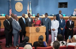 Chairwoman Edmonson, joined by Commissioner Dennis Moss, honors the Hunger Nine at the May 7 County Commission meeting. (Photo by Ryan Holloway / Miami-Dade County)  