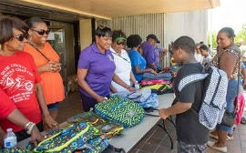 Chairwoman Edmonson gives away free book bags to schoolchildren.  (Photos by Godfrey Mead / Miami-Dade County)   