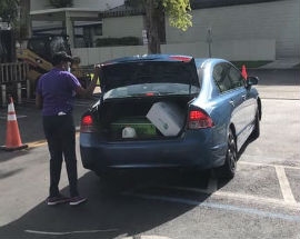 Chairwoman Edmonson helps load food into a resident’s trunk at the June 27 drive-through food distribution.
