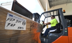 FFP Warehouse) Workers at Food For The Poor's Coconut Creek warehouse packed a tractor-trailer load of food headed to Haiti to help families who have struggled to find food for two weeks due to violent protests in the country. A special prayer service, followed by a reception is planned for Thursday, Feb. 28, from 4 to 6 p.m. at the Food For The Poor headquarters, 6401 Lyons Road, Coconut Creek, Fla. (Photo/Food For The Poor)