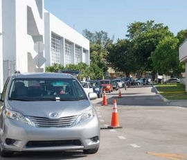 Cars line up at the Caleb Center for the food distribution.