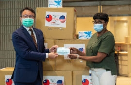 Chairwoman Edmonson, right, accepts a donation of 20,000 face masks from David K.C. Chien, Director General of the Taipei Cultural and Economic Office in Miami.  (Photo by Godrey Mead)   