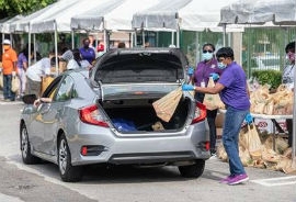Chairwoman Edmonson loads food into a resident’s trunk.  (Photos by Armando Rodriguez / Miami-Dade County)