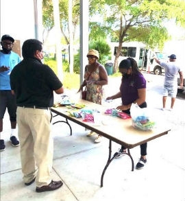 Elder Affairs Advisory Board (EAAB)Member Karen Bullard-Jordan with Chairwoman Audrey M. Edmonson’s Chief of Staff, Misty Brown, at Charles Hadley Park delivering masks