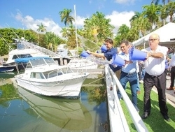In lieu of the traditional shovel groundbreaking, (L to R) Miami City Commission Chairman Ken Russell, Miami Mayor Francis Suarez and Miami City Manager Emilio T. Gonzalez perform the ceremonial water toss to mark the start of the first Miami Forever Bond project tackling flooding and sea-level rise. Photo: City of Miami Office of Communications