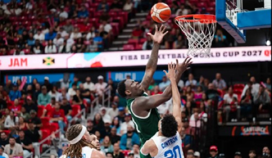 Jamaica’s Kofi Cockburn (centre) completes a lay-up over Puerto Rico’s Jordan Cintron during the first-round FIBA Americas World Cup qualifier in San Juan on November 28, 2025.