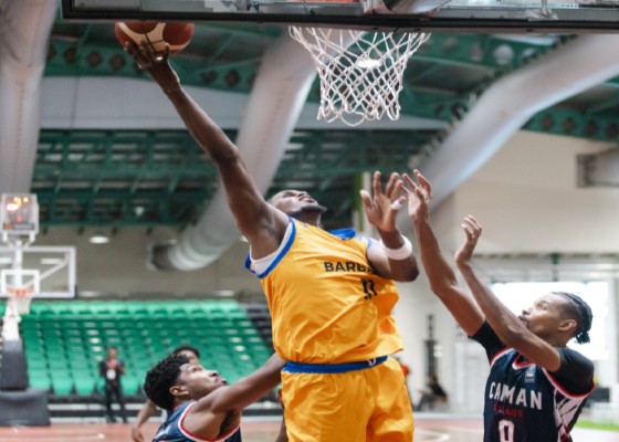 Barbados’ Kyrone Alexander goes up for two of his team-high 15 points against the Cayman Islands. (Photo courtesy FIBA)