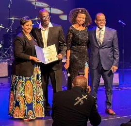 Charmaine Williams, minister of Women's Social and Economic Opportunities For the Province of Ontario, presents Mark "Tony Anthony" Bennett, founder of the Reggae North Music Awards, with a proclamation for his contribution to reggae in Canada. Third from left is Joan John, councilor for Southgate township in Ontario, and Garnett Manning, adviser to the mayor of Brampton. Occasion was the inaugural Reggae North Music Awards, held at the Rose Theatre in Brampton on September 29.