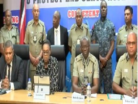 Deputy Commissioner of Police (DCP) Suzette Martin (in civilian clothes) flanked by police officers addressing news conference on Friday (CMC Photo)