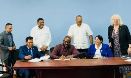 MOU being signed by the Managing Director of RioMed Limited Mario Mohamed (Sitting L) and Permanent Secretary of the Ministry of Health, Malcolm Watkins