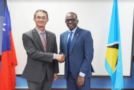 Prime Minister Phillip J Pierre and Taiwanese Ambassador to St. Lucia, Peter Chia-yen Chen, shae hands at the signing cermony