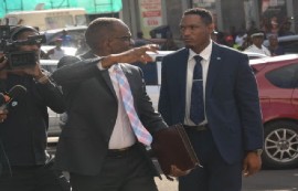 Prime Minister Phillip J Pierre acknowledges the cheers from the crowd as he makes his way into the Parliament building on Friday for the swearing in ceremony of the new Cabinet.