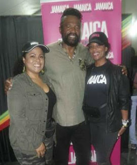 Camile Glenister, Deputy Director of Tourism, Marketing at the JTB (left) and Safi James-Barrow, Destination Marketing Manager at the JTB pose with festival principal Tony Rebel 