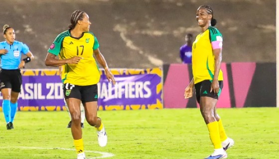 Khadija Shaw (right) celebrates after opening the scoring for Jamaica against Guyana on Saturday.