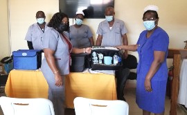SRHA Acting Regional Mental Health Officer, Karen Elliott (left) presents  the restraints to Director of Nursing Services, Maria Stampp for the Black  River Hospital (right). Photographed also are (back-left to right)-Psychiatric Nursing Aides- Omar Daley, Denetra Tucker-Steele and Patrick Henry.