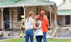 Minister in the Prime Minister’s Office with responsibility for culture Senator Dr Shantal Munro-Knight (centre) being comforted at the scene of the fire.