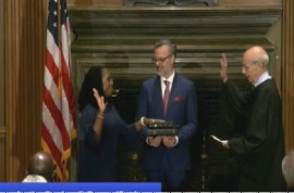 Ketanji Brown Jackson being sworn in as a Judge of the US Supreme Court watched by her husband.